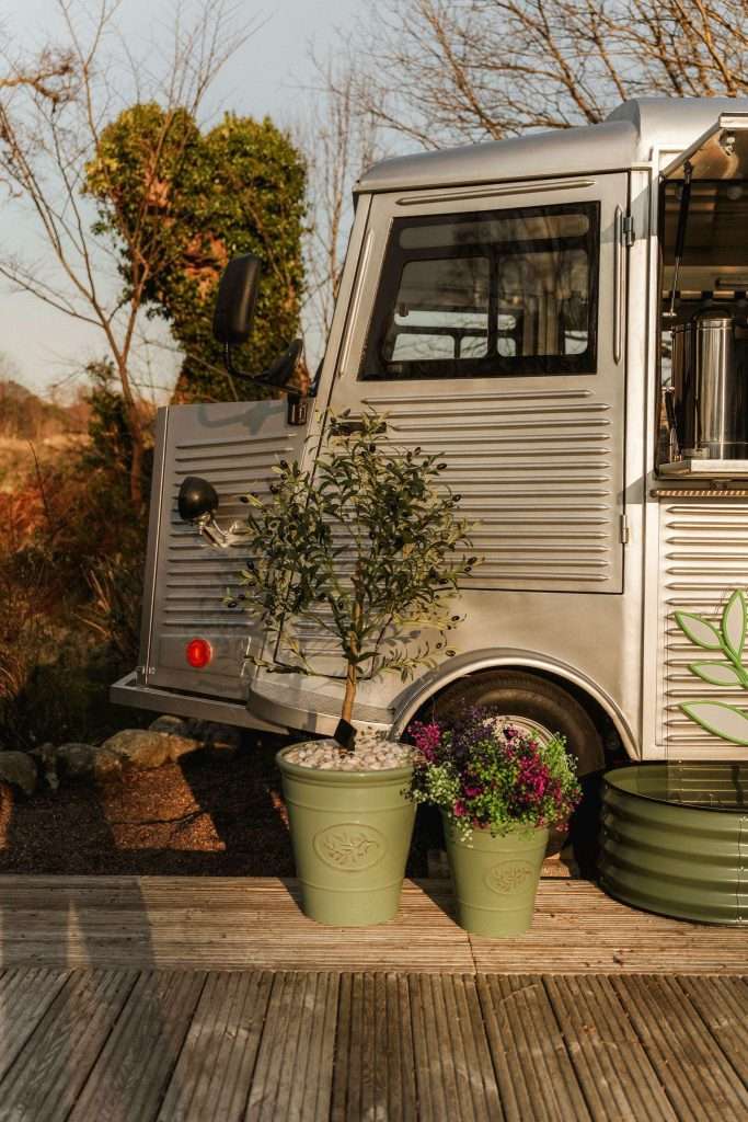 Kitchen food truck looking beautiful with pot plants and sunset at Woodlands Glencoe.