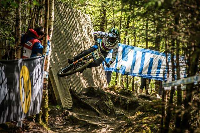 A downhill biker making his way down a black run at Nevis Range.