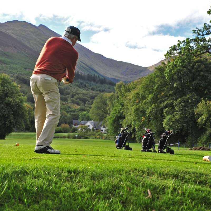 A golfer swinging at Woodlands Glencoe Golf Course