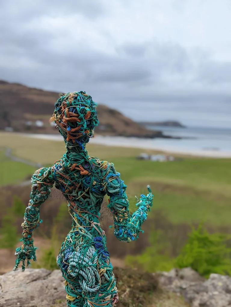 A figure made of old fishing ropes overlooks Calgary Beach on the Isle of Mull.