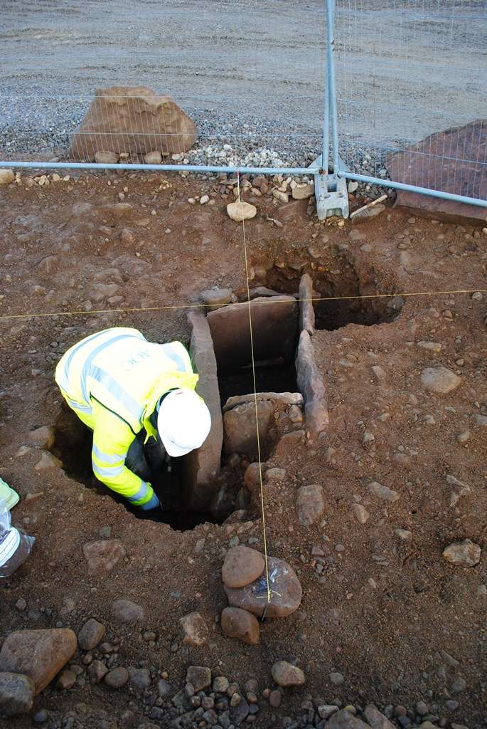 An archeologist digs out a burial cist in Drumnadrochit in the Highlands.