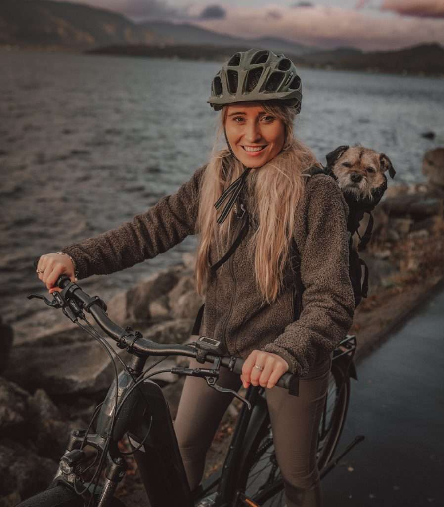 E-biking with a dog in a backpack from Woodlands Glencoe Activity Centre. Dog friendly luxury lodges in Glencoe.