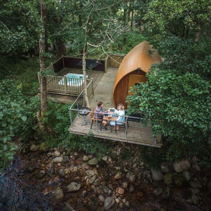A couple enjoy breakfast at RiverBeds Luxury Wee Lodges.