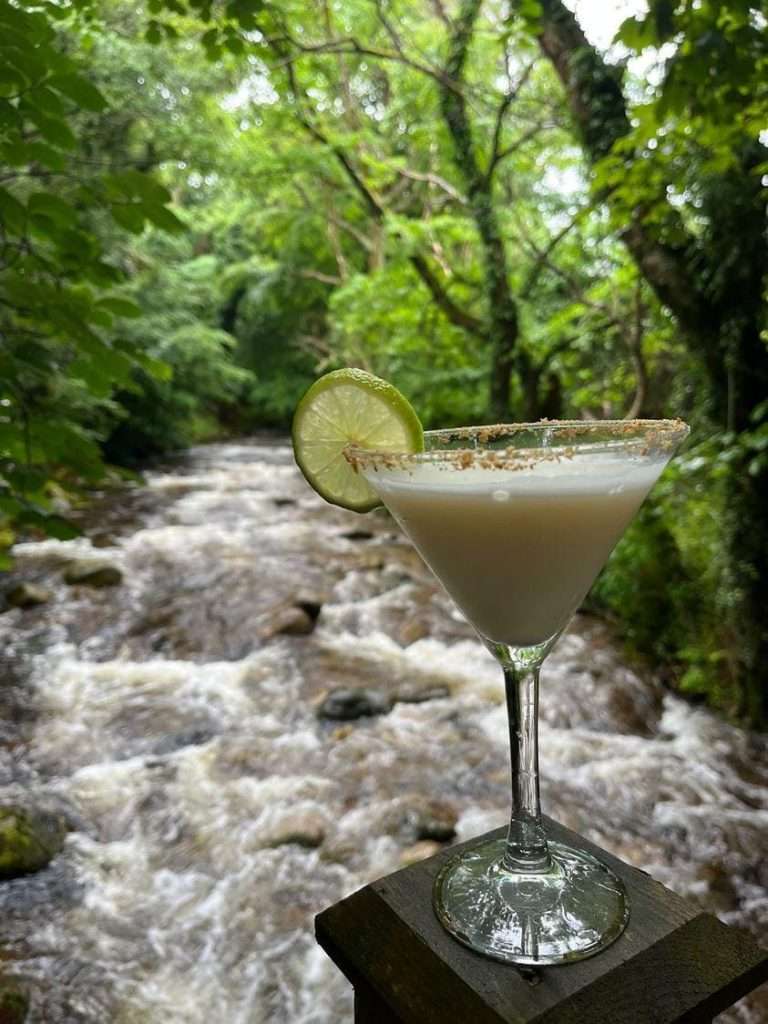 A cocktail above the rattling river at Woodlands Glencoe.
