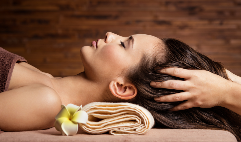 A lady enjoys a head massage at Woodlands Wellness in Glencoe.