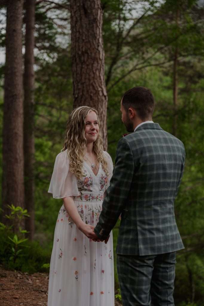 A couple get married in the forest at Glencoe Lochan close to Woodlands Glencoe.