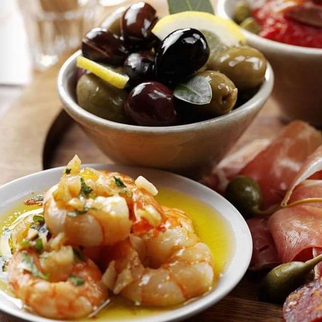 Dishes of Langoustines and olives at Lochleven Seafood Cafe which is just a fifteen minute drive from Woodlands Glencoe and is definitely one of the best restaurants in Glencoe.