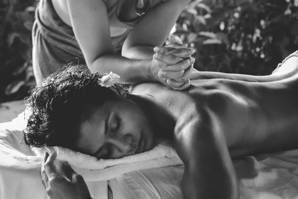 A lady enjoys a reiki massage at Woodlands Glencoe Luxury Lodges with hot tubs Scotland.