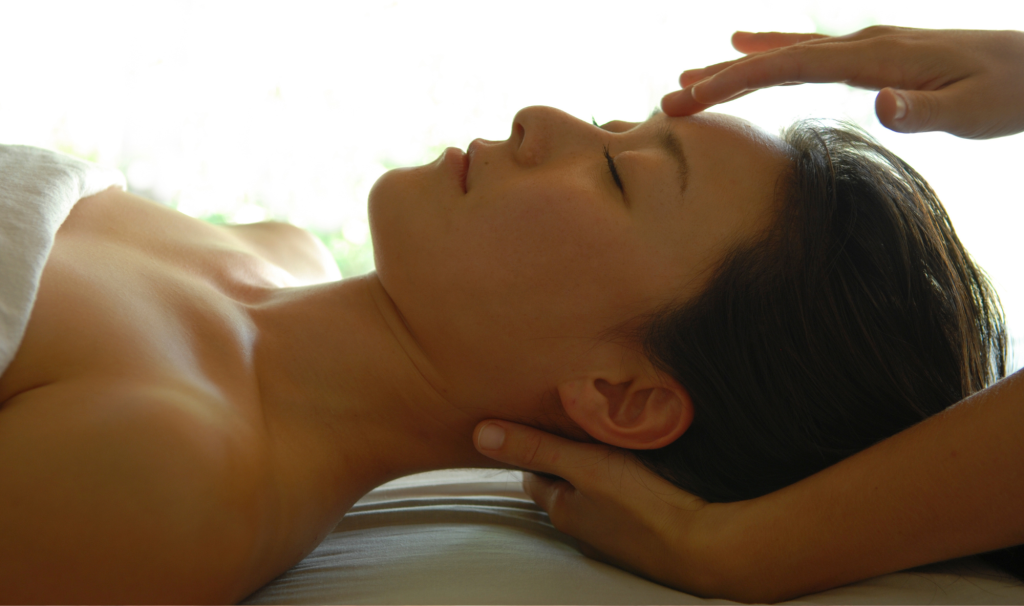 A guest at Woodlands Glencoe enjoys a reiki session at Woodlands Wellness.