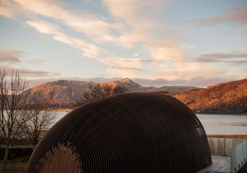 The mountain and loch view from SeaBeds Luxury Lookout Lodges with Hot Tubs at Woodlands Glencoe in the autumn and winter.