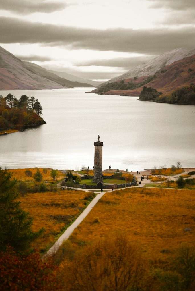 The Glenfinnan monument in autumn with loch shiel in the background.
