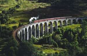 The Jacobite Steam Train or Hogwarts Express goes over Glenfinnan Viaduct.