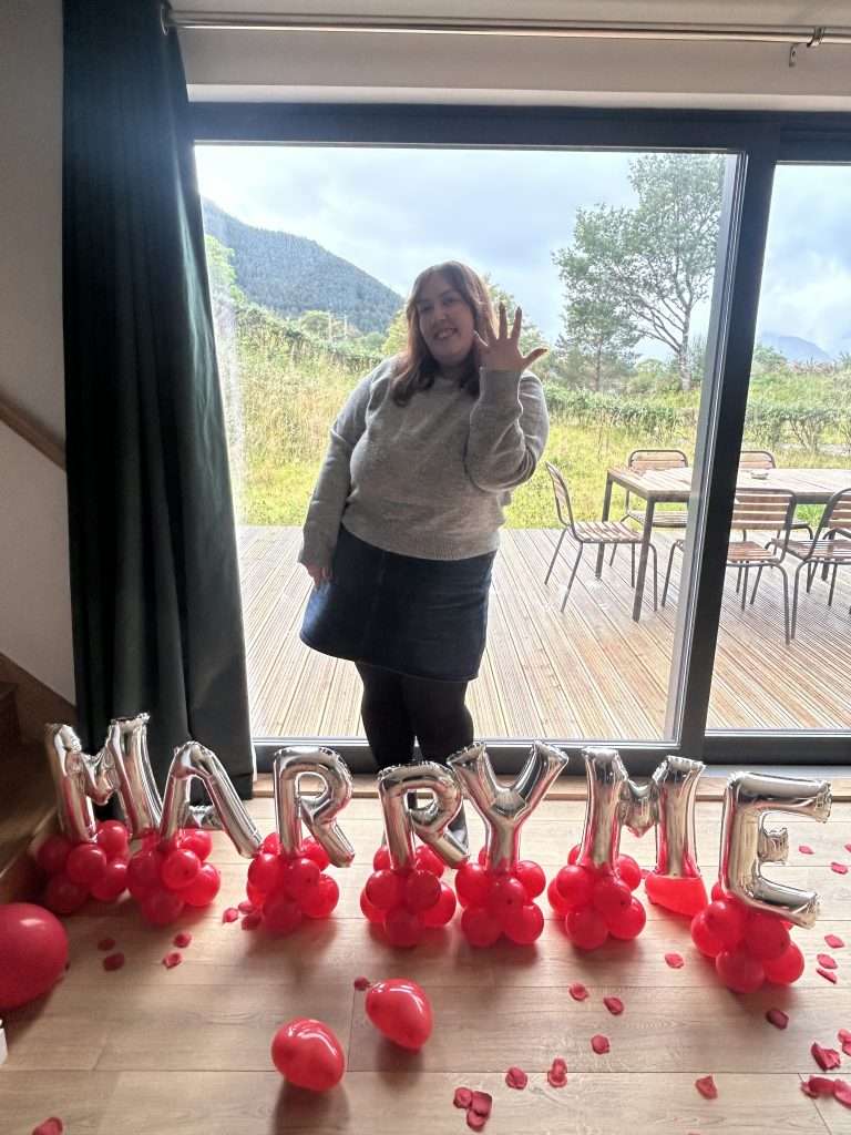 A lady walks into Forest Corner to be surprised by Marry Me balloons! Unique proposals in Glencoe!