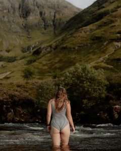 A lady goes wild swimming in the River Coe.