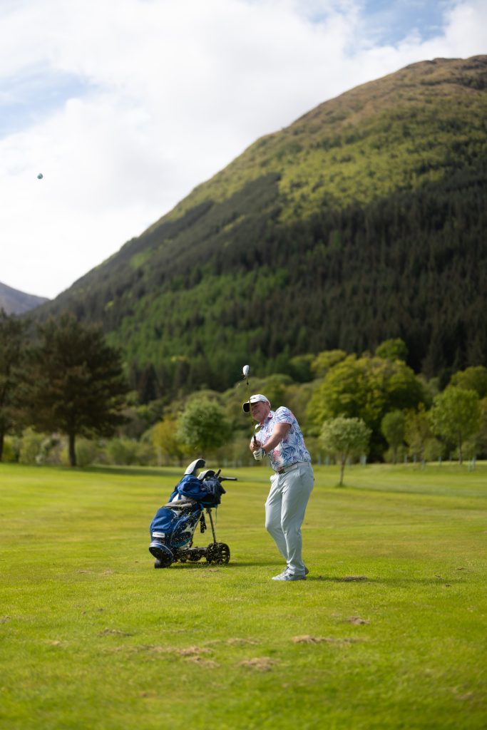 A golfer swings big at Woodlands Glencoe Golf Course.