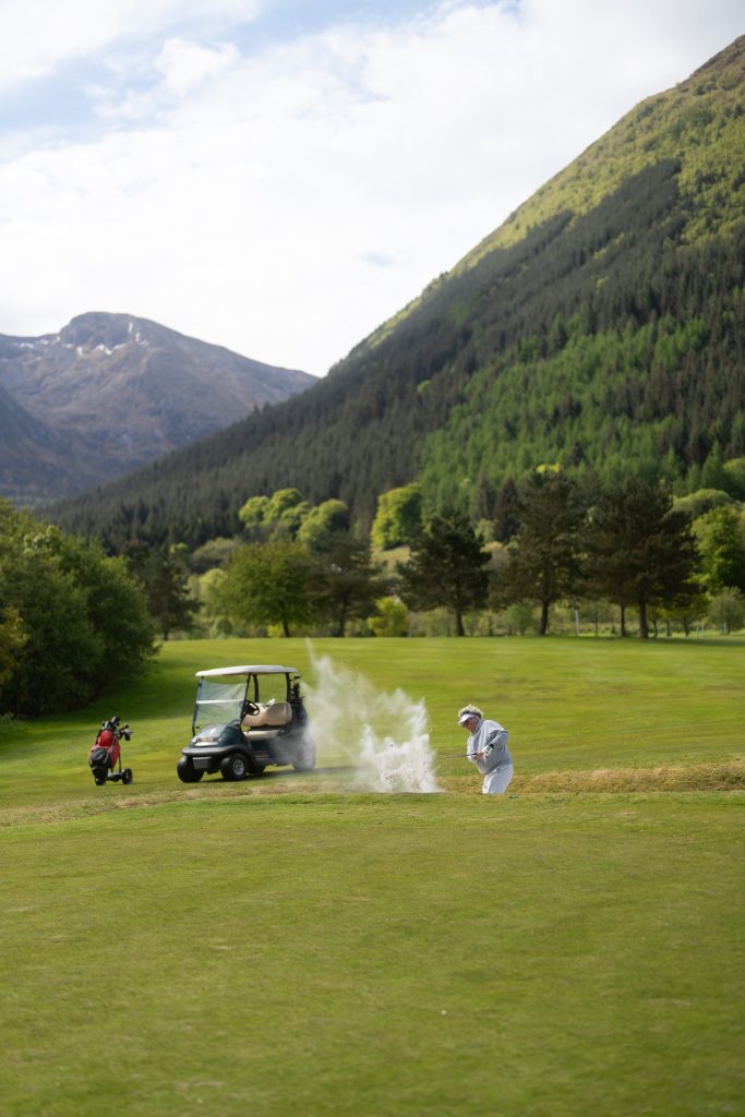 A golfer swings from the sand at Woodlands Glencoe Golf Course.